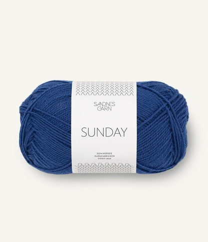 A ball of Sandnesgarn Sunday merino wool yarn in a blue color, with packaging that includes the brand and product name.
