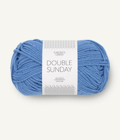 A ball of blue coloured merino wool yarn labeled 'Double Sunday' by Sandnesgarn.