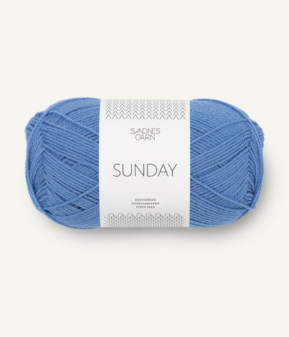 A ball of Sandnesgarn Sunday merino wool yarn in a light blue color, with packaging that includes the brand and product name.