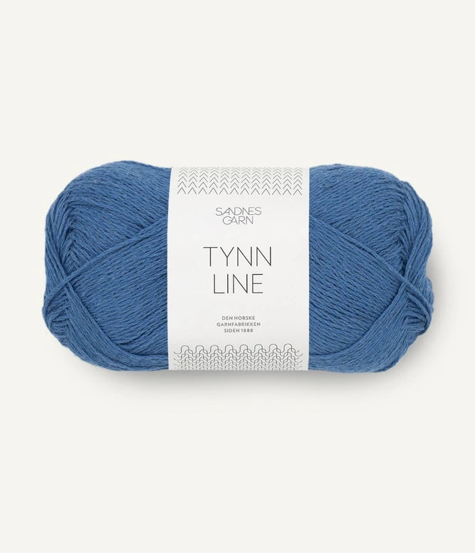 A ball of dusty blue cotton/linen/viscose yarn labeled 'TYNN LINE' by Sandnes Garn