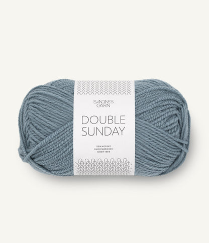 A ball of blue-grey coloured merino wool yarn labeled 'Double Sunday' by Sandnesgarn.