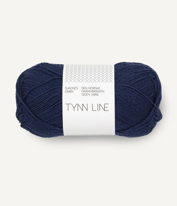 A ball of deep navy cotton/linen/viscose yarn labeled 'TYNN LINE' by Sandnes Garn