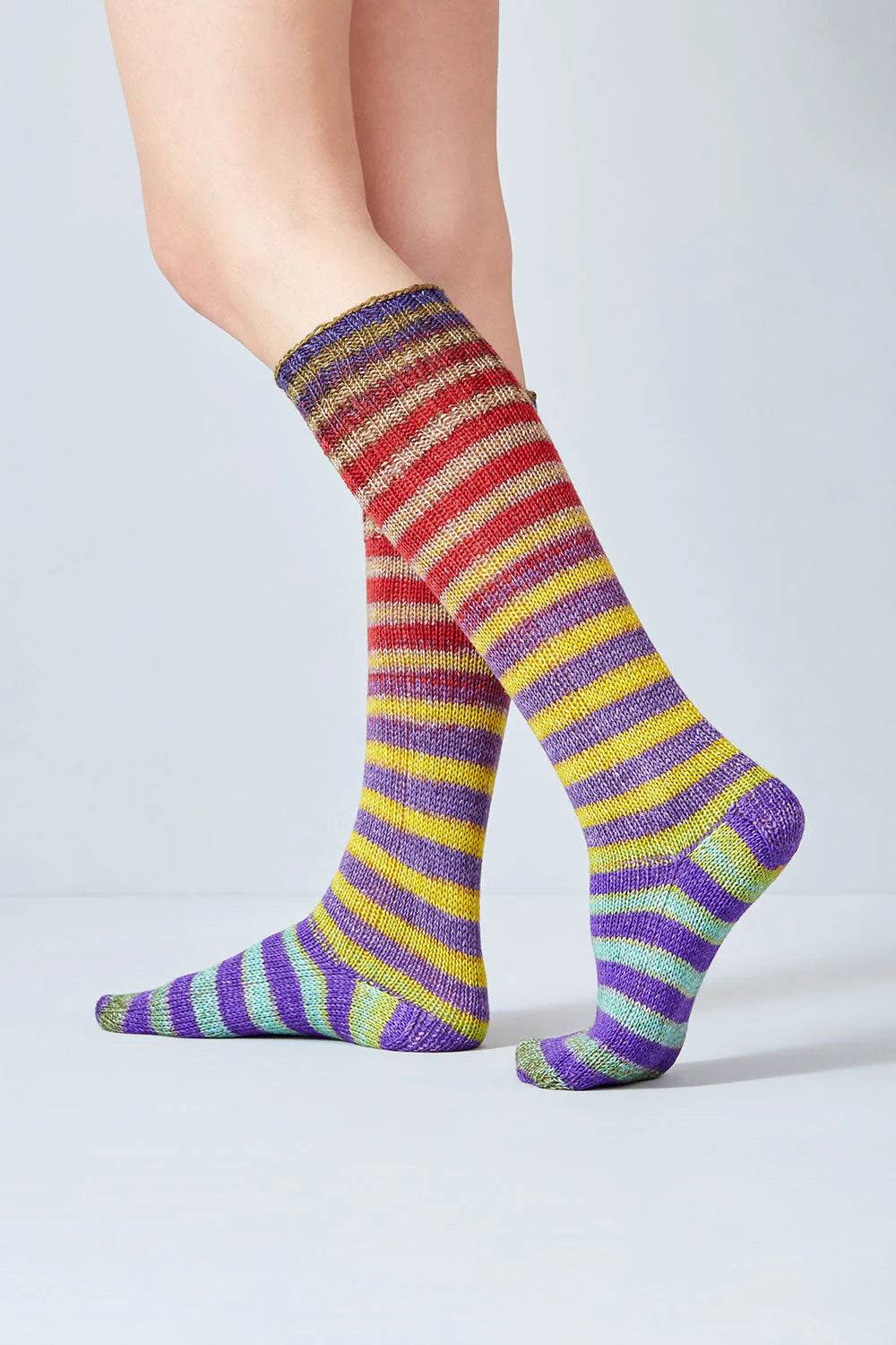 Merino and nylon knit purple, yellow, red, and teal stripe socks from Urth