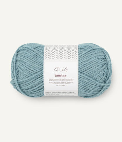 Ball of pale ocean coloured yarn with a label on a white background