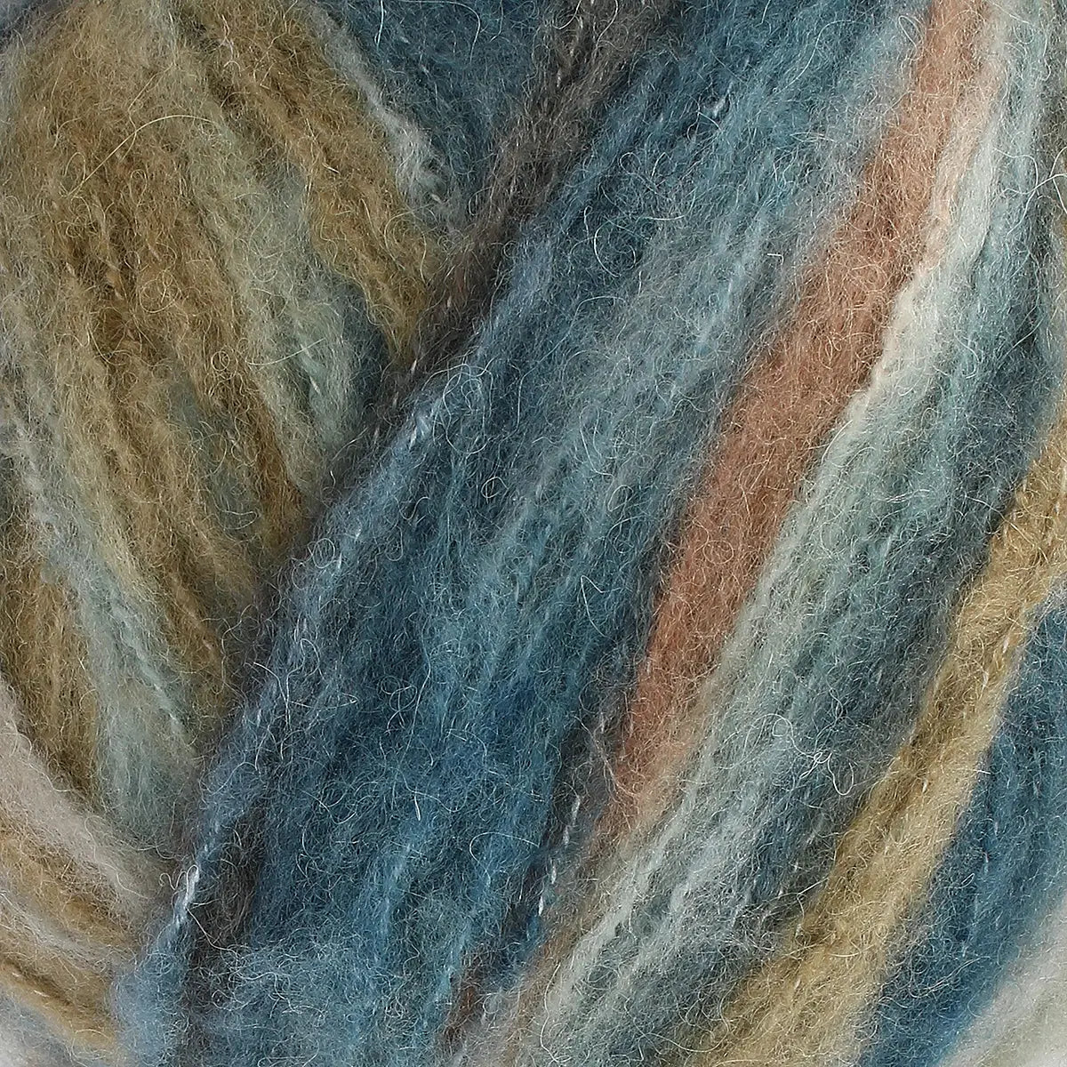 A close-up of acrylic, mohair, polyester, and wool yarn in yarn with blue, brown, and beige tones