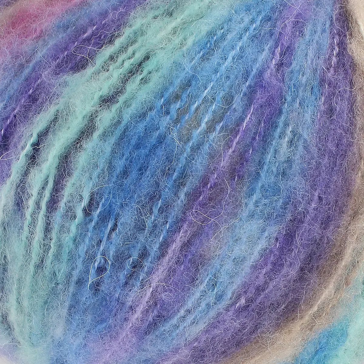 A close-up of acrylic, mohair, polyester, and wool yarn in blue, pink, and purple colours