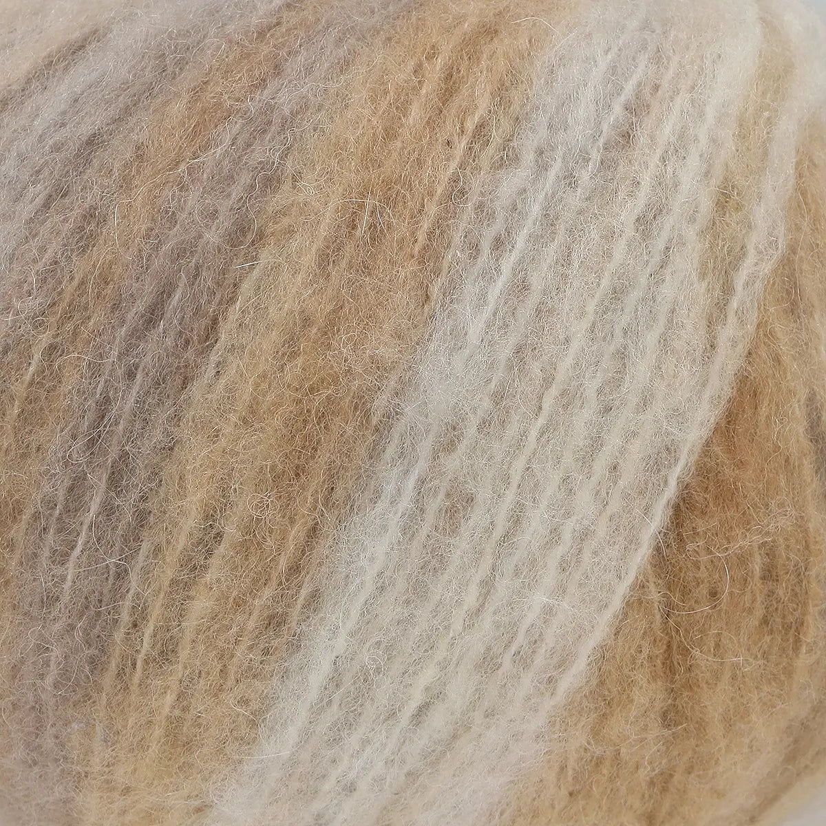 A close-up of acrylic, mohair, polyester, and wool yarn in white, brown and beige colours