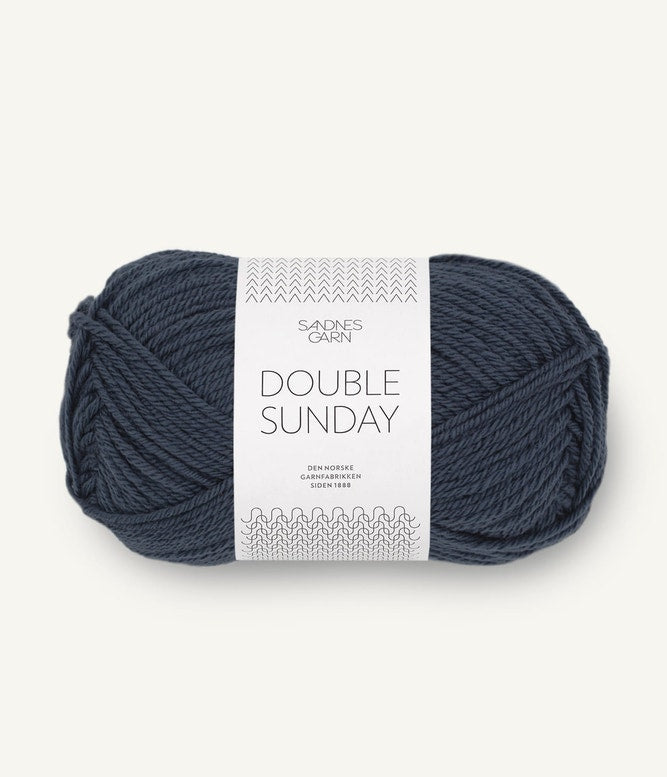A ball of dark grey-blue coloured merino wool yarn labeled 'Double Sunday' by Sandnesgarn.