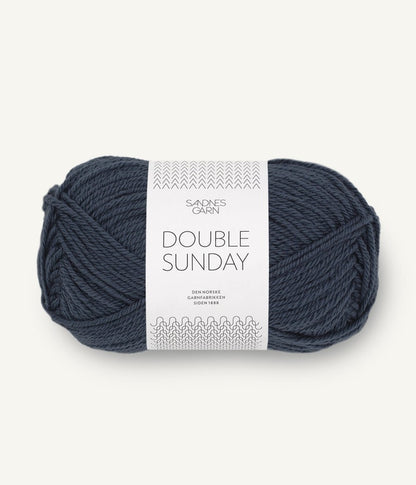 A ball of dark grey-blue coloured merino wool yarn labeled 'Double Sunday' by Sandnesgarn.