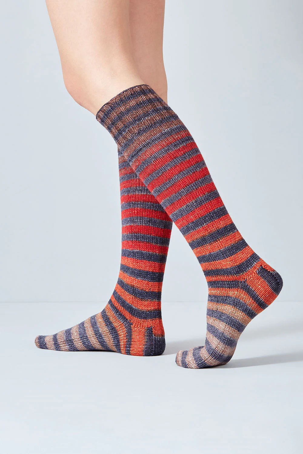 Merino and nylon knit red, orange, and grey stripe socks from Urth