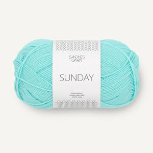 A ball of Sandnesgarn Sunday merino wool yarn in a turquoise color, with packaging that includes the brand and product name. 
