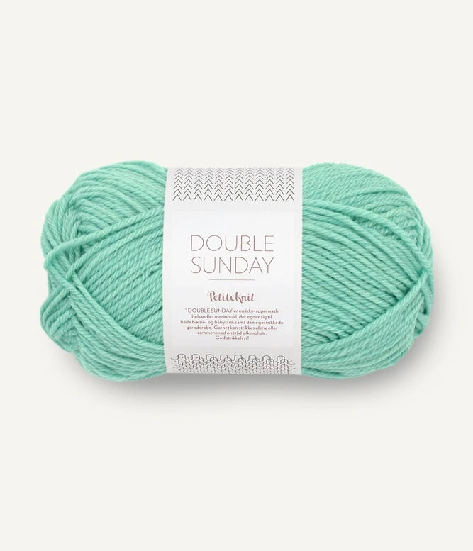 A ball of mint coloured merino wool yarn labeled 'Double Sunday' by Sandnesgarn.