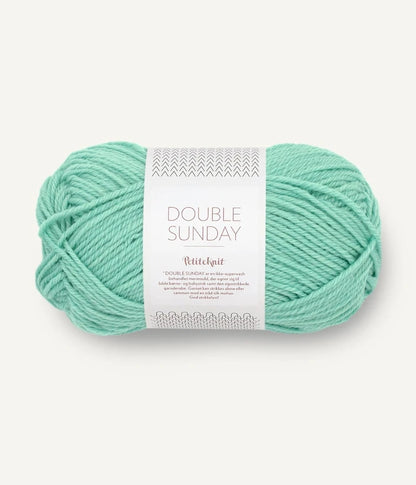 A ball of mint coloured merino wool yarn labeled 'Double Sunday' by Sandnesgarn.