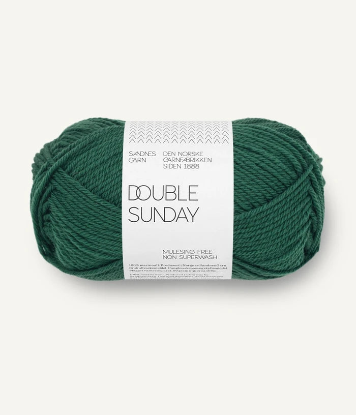 A ball of emerald green coloured merino wool yarn labeled 'Double Sunday' by Sandnesgarn.