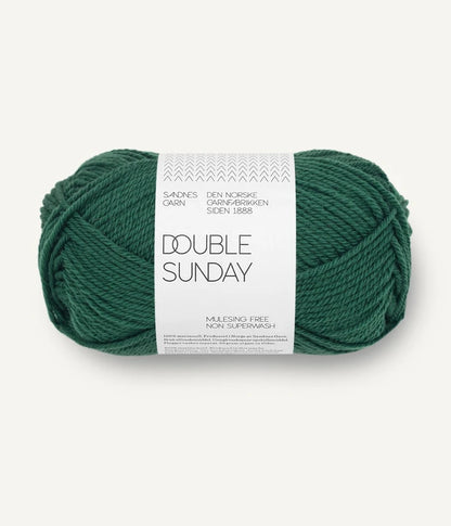 A ball of emerald green coloured merino wool yarn labeled 'Double Sunday' by Sandnesgarn.