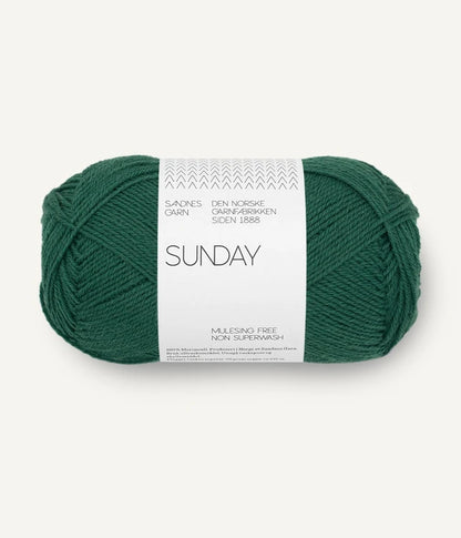 A ball of Sandnesgarn Sunday merino wool yarn in a green color, with packaging that includes the brand and product name.