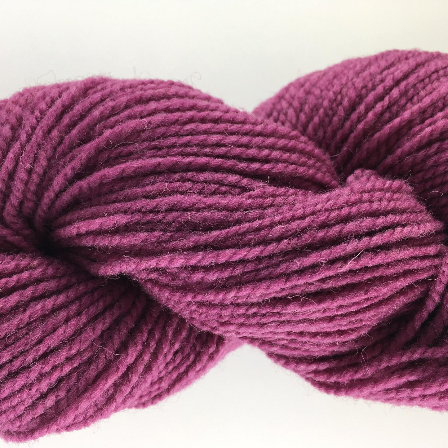 Close-up of a skein of rose coloured wool yarn