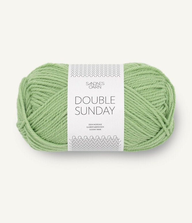 A ball of light green coloured merino wool yarn labeled 'Double Sunday' by Sandnesgarn.