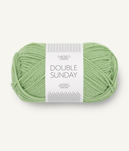 A ball of light green coloured merino wool yarn labeled 'Double Sunday' by Sandnesgarn.