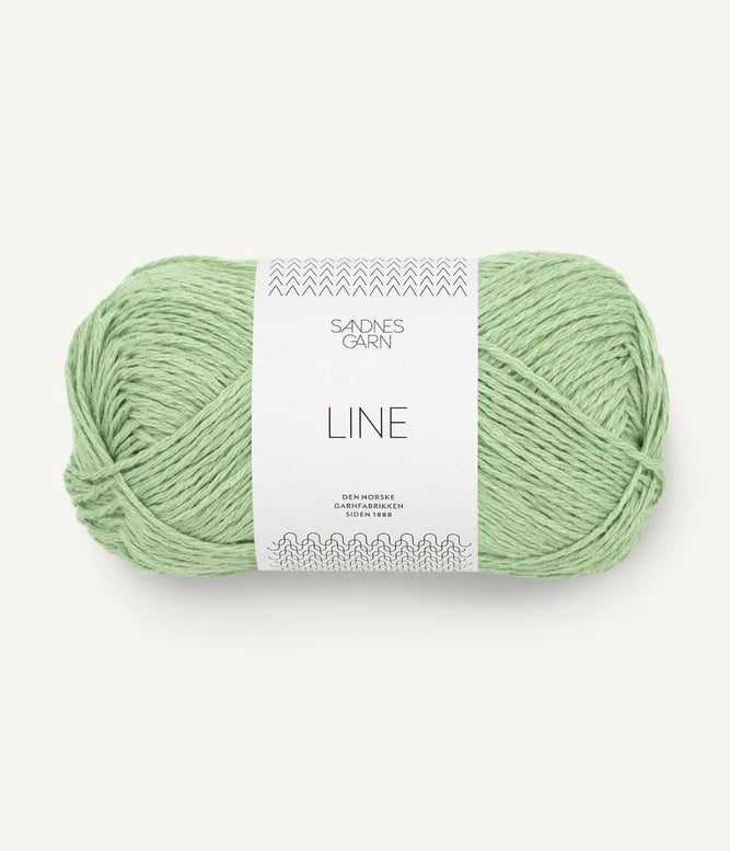 A ball of spring green coloured cotton/linen/viscose yarn labeled 'Line' by Sandnesgarn