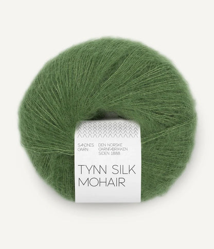 A ball of Tynn Silk Mohair yarn in a soft green color with a 'Tynn Silk Mohair' label from Sandnes Garn