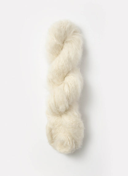 An off-white skein of brushed suri, merino, and bamboo yarn from Bluesky Fibers