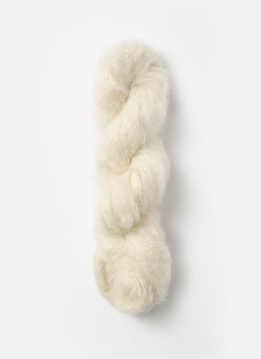 An off-white skein of brushed suri, merino, and bamboo yarn from Bluesky Fibers
