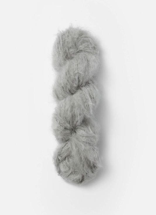 A light grey skein of brushed suri, merino, and bamboo yarn from Bluesky Fibers