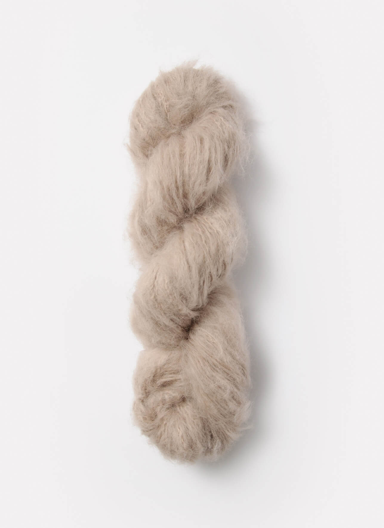 A light tan skein of brushed suri, merino, and bamboo yarn from Bluesky Fibers