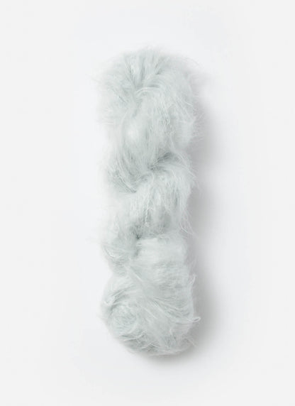 A white skein of brushed suri, merino, and bamboo yarn from Bluesky Fibers