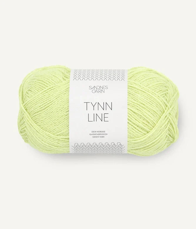 A ball of bright lime cotton/linen/viscose yarn labeled 'TYNN LINE' by Sandnes Garn