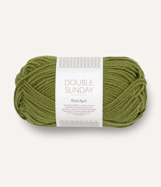 A ball of medium green coloured merino wool yarn labeled 'Double Sunday' by Sandnesgarn.