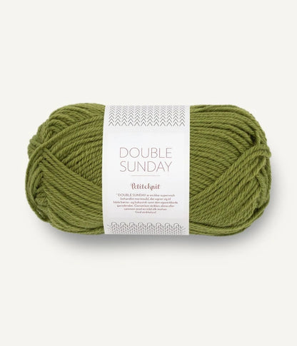 A ball of medium green coloured merino wool yarn labeled 'Double Sunday' by Sandnesgarn.