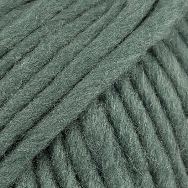 Close-up of a ball of muted green-colored wool yarn from Drops