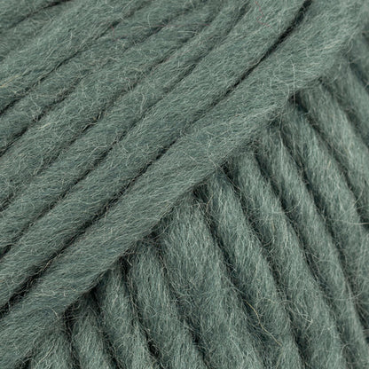 Close-up of a ball of muted green-colored wool yarn from Drops