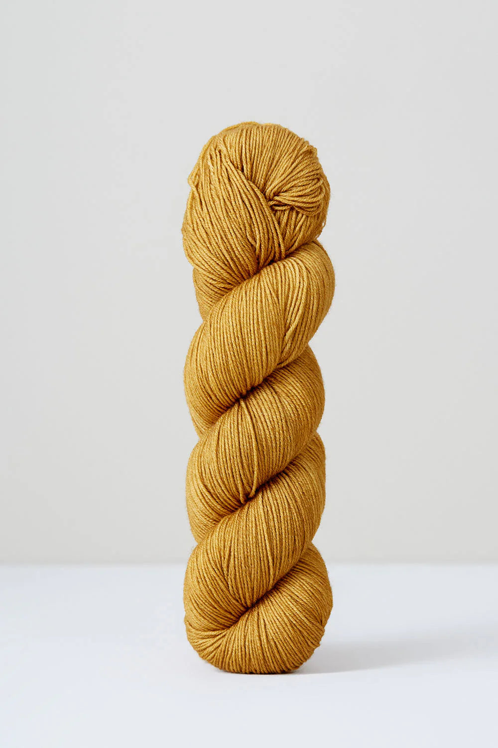 A skein of mustard/brown superwash merino wool from Urth 