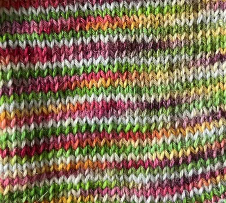 Close up knitted swatch of Blooming Bright yarn