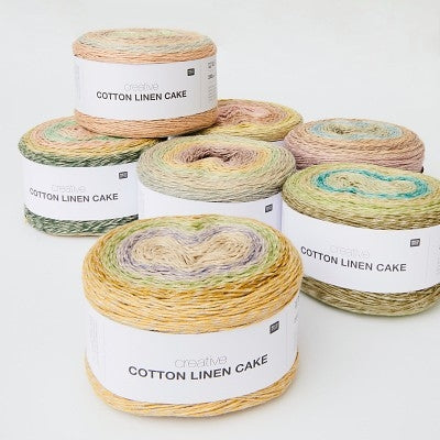 Rolls of pastel variegated yarn labeled 'Creative Cotton Linen Cake'.