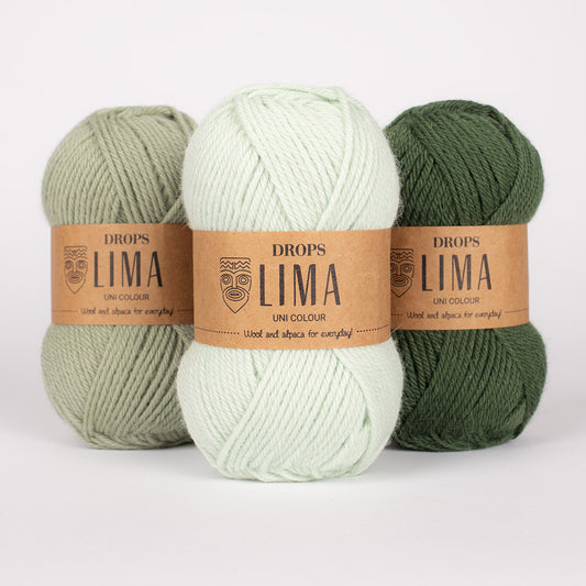 Three skeins of yarn in green and white with 'DROPS Lima' labels on a white background