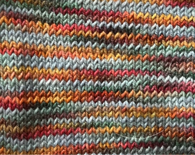 Close up knitted swatch of Falling River yarn