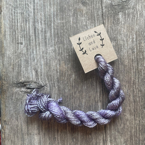 A skein of Lilac purple embroidery yarn labelled 'Lichen and Lace'.