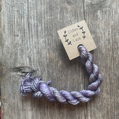 A skein of Lilac purple embroidery yarn labelled 'Lichen and Lace'.