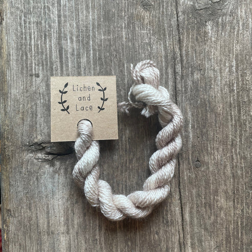 A skein of Linen beige embroidery yarn labelled 'Lichen and Lace'.