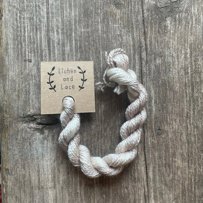 A skein of Linen beige embroidery yarn labelled 'Lichen and Lace'.