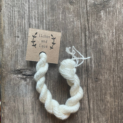 A skein of Natural white embroidery yarn labelled 'Lichen and Lace'.