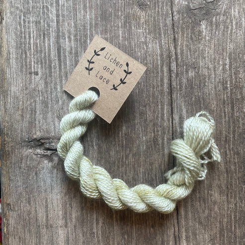 A skein of Sage green embroidery yarn labelled 'Lichen and Lace'.