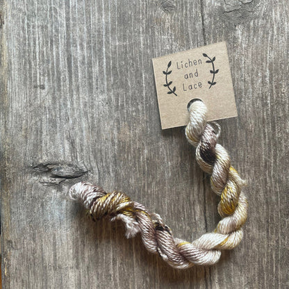 A skein of Shroom beige embroidery yarn labelled 'Lichen and Lace'.
