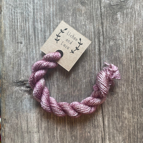 A skein of Sugar Plum pink embroidery yarn labelled 'Lichen and Lace'.