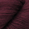 Close-up image of a skein of Garnet red colored baby llama yarn.