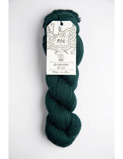 Dark green skein of yarn with a 'Ayni' label on a white background